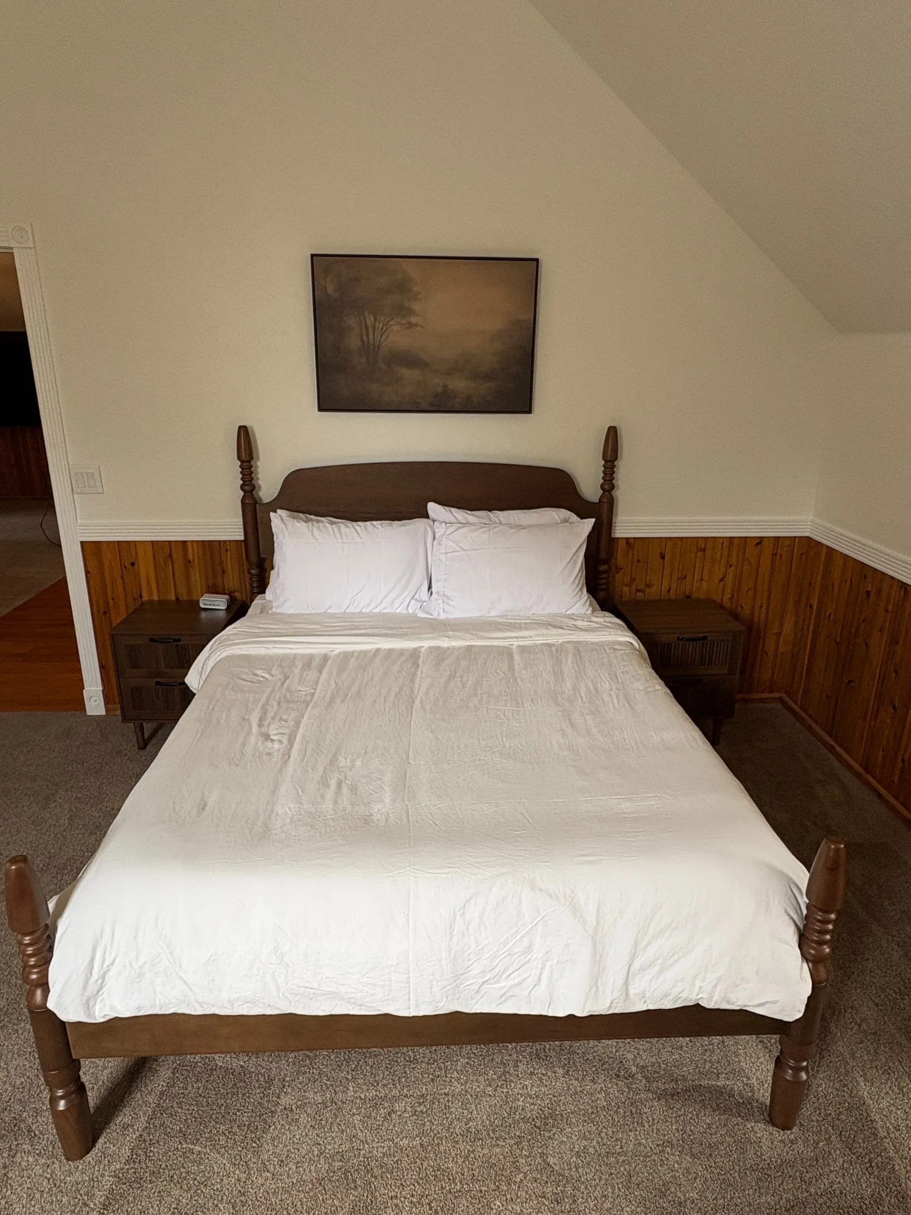 The queen bed in Harper’s Room, made up with white linens.