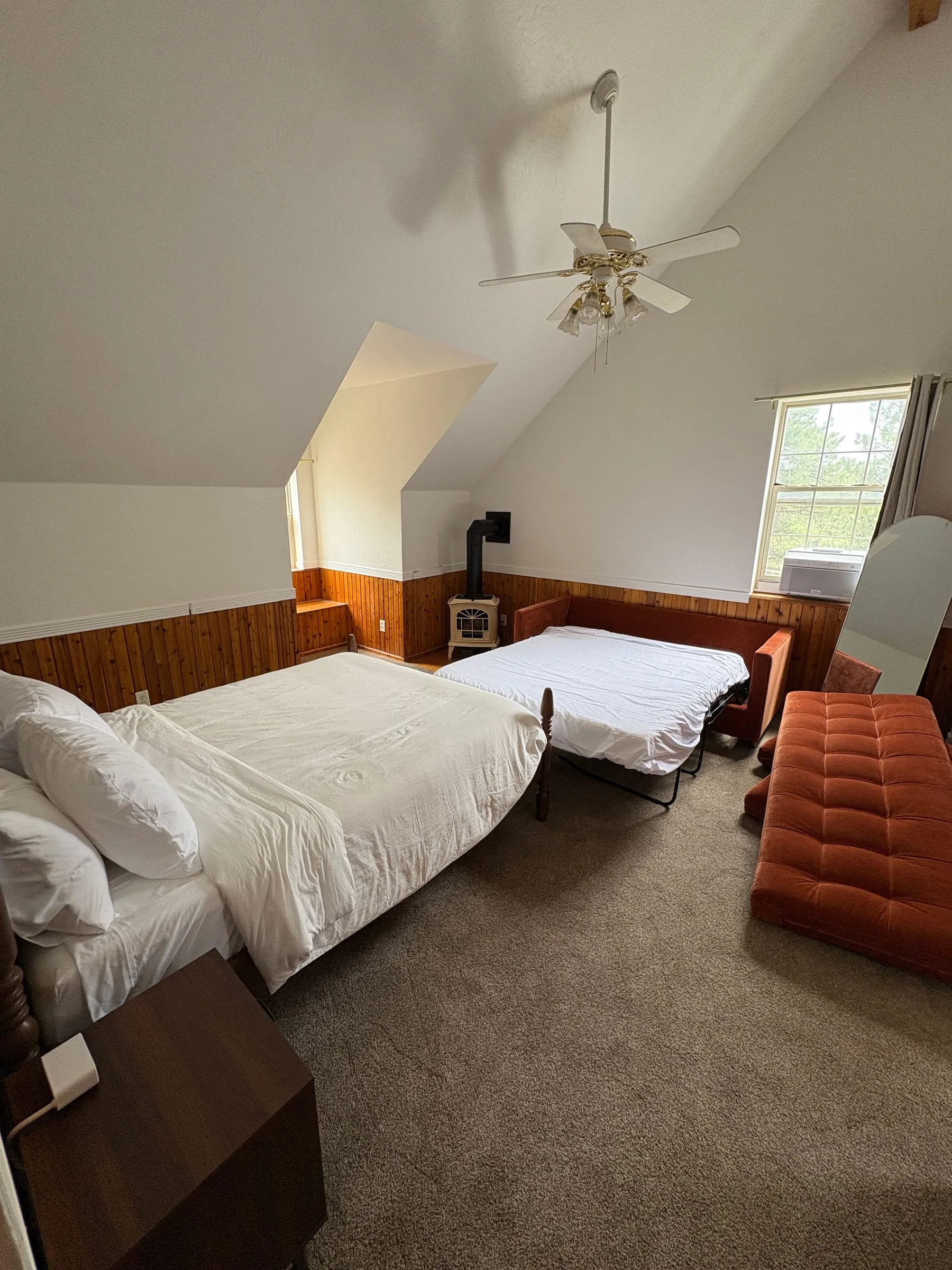 Harper’s Room with the sleeper sofa pulled out into a bed beside the queen. Both beds fit with floor space left over.