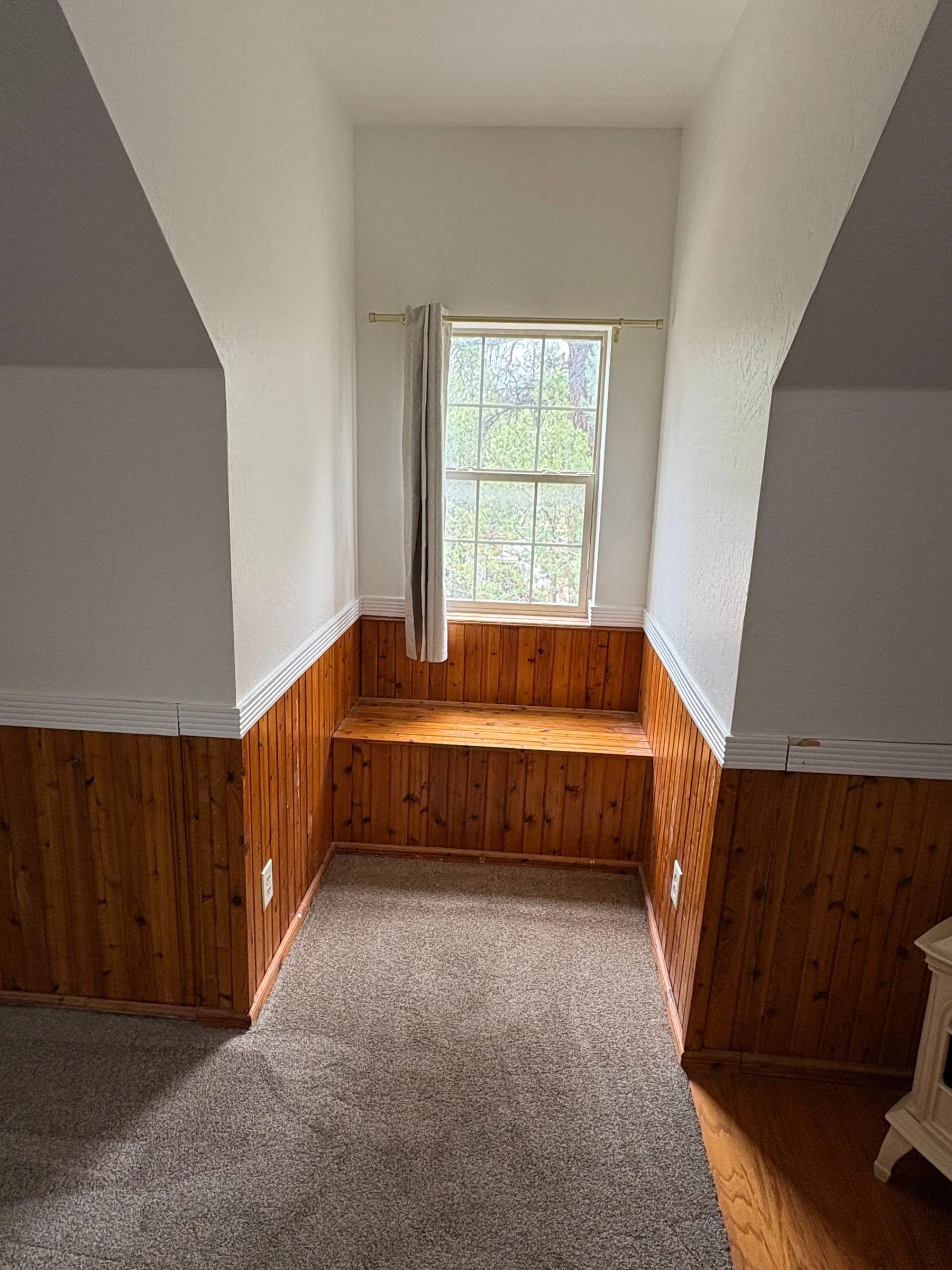 A built-in window seat in Harper’s Room, set into the dormer beneath the window.