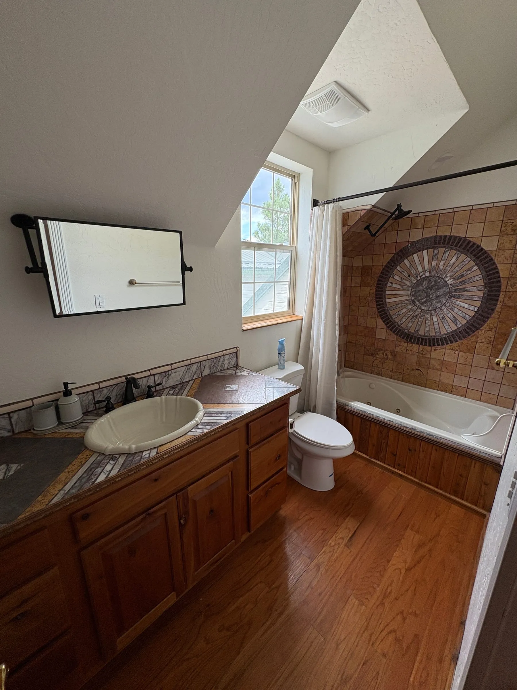The ensuite bathroom in Jane’s Room, with a shower and a tub.