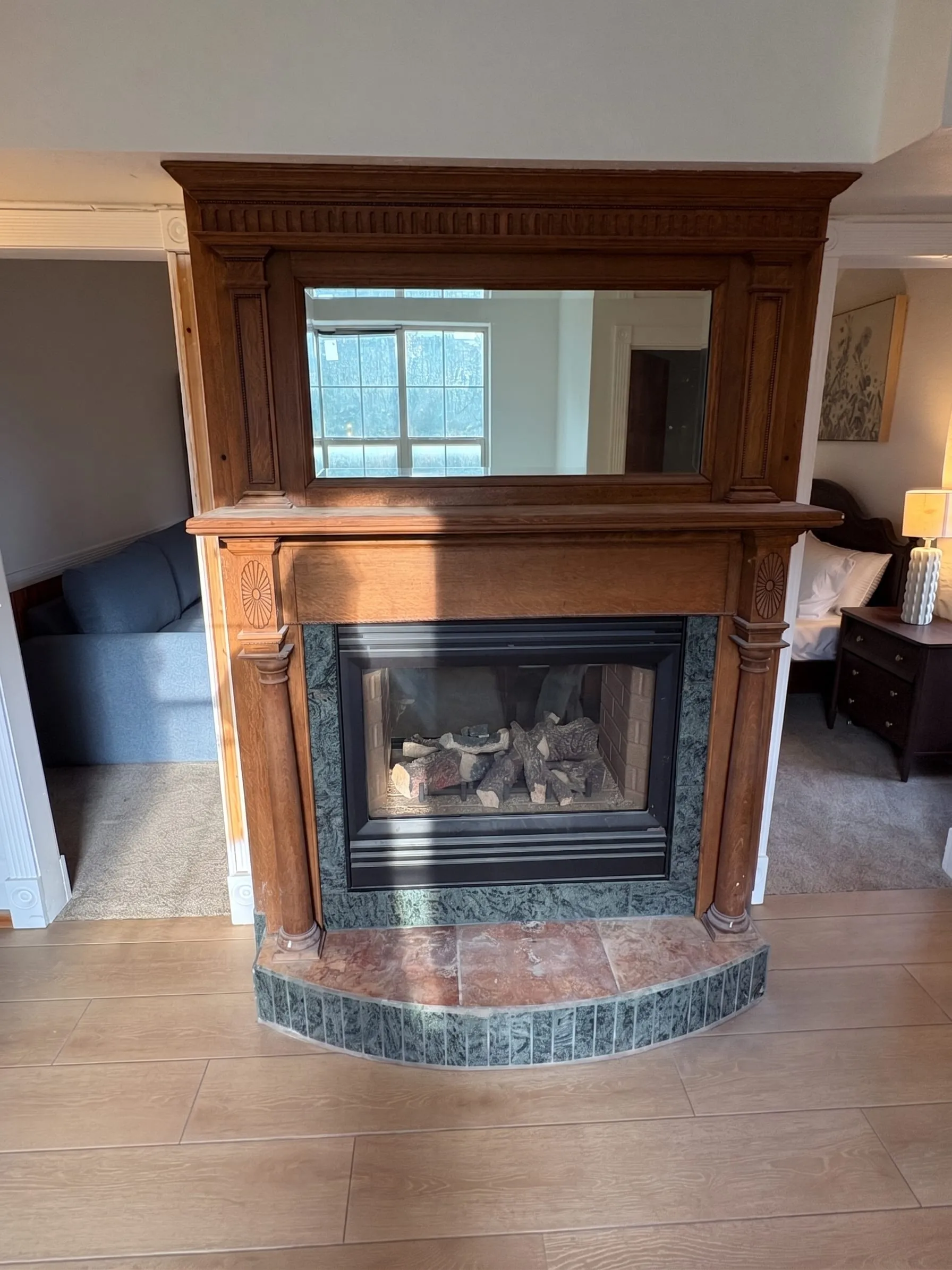 The view from the freestanding tub, looking back through the two-way fireplace toward the bedroom.