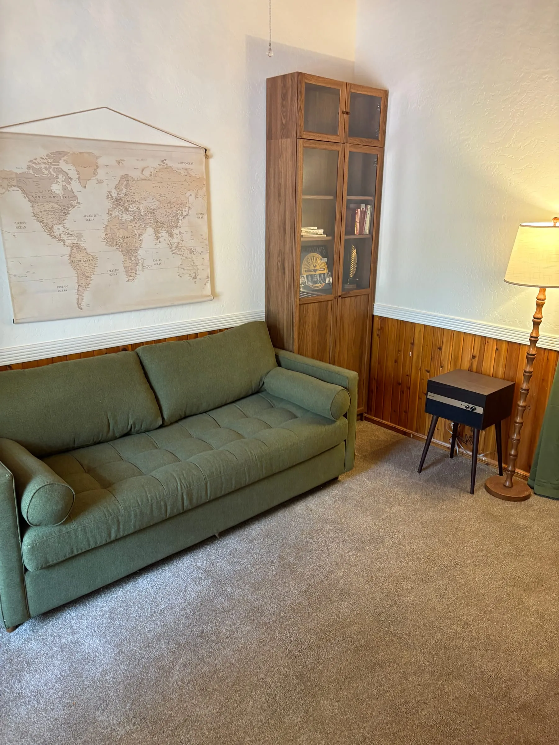 Another angle on the Study, showing the bookcases, the reading lamp, and the green sofa.