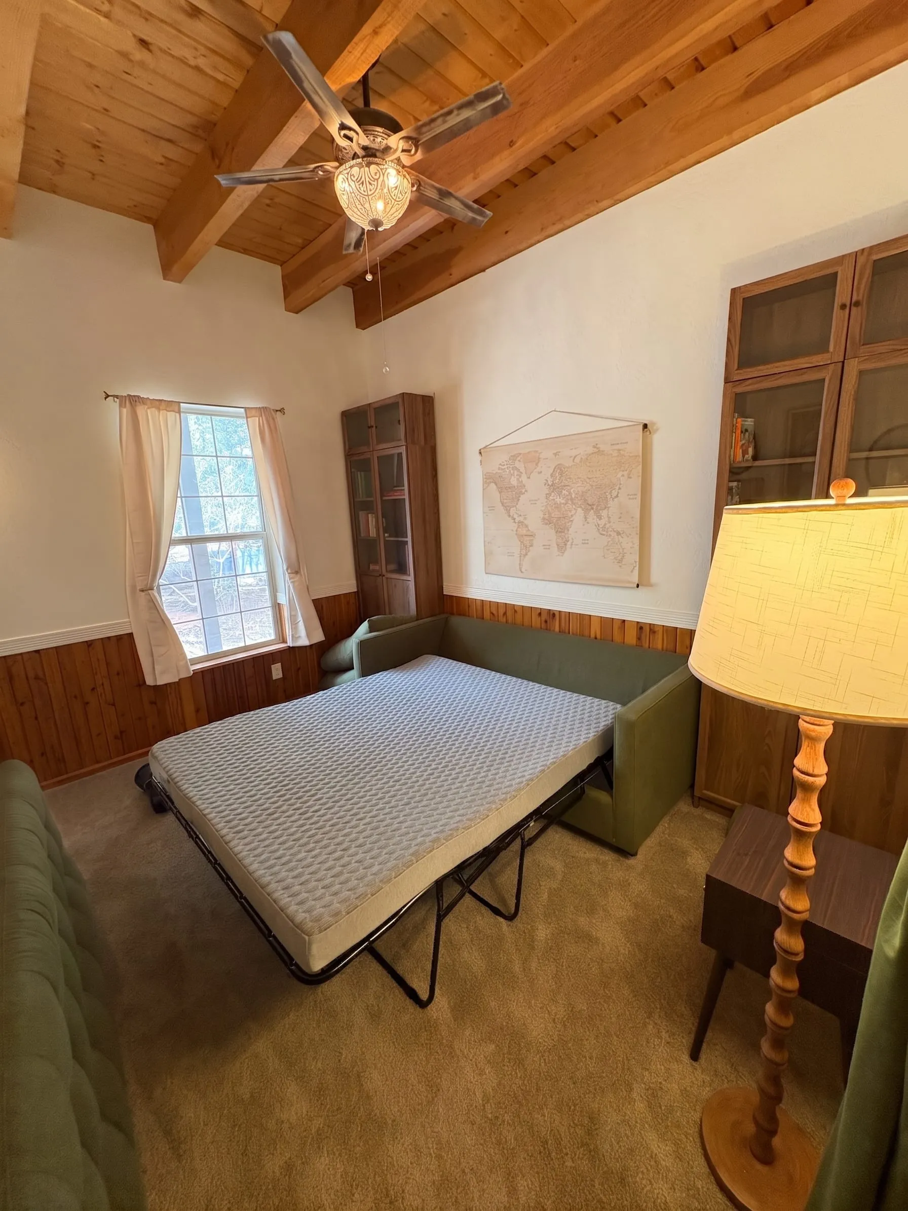 The Study with the sofa converted into a bed. The room has curtains across both entrances rather than doors.